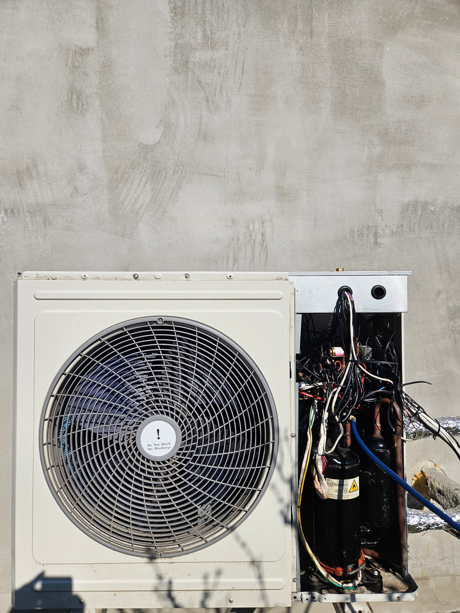 Otvorena spoljna jedinica klime tokom remonta. Pristup kompresoru i ventilatoru za kompletnu dijagnostiku i popravku.